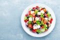 Greek salad of fresh cucumber, tomato, sweet pepper, lettuce, red onion, feta cheese and olives with olive oil Royalty Free Stock Photo