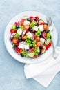 Greek salad of fresh cucumber, tomato, sweet pepper, lettuce, red onion, feta cheese and olives with olive oil Royalty Free Stock Photo