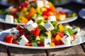 Greek salad of fresh cucumber, tomato, sweet pepper, lettuce, red onion, feta cheese and olives with olive oil. Healthy food, Royalty Free Stock Photo