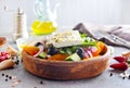 Greek salad of fresh cucumber, tomato, sweet pepper, lettuce, red onion, feta cheese and olives with olive oil. Healthy food, top Royalty Free Stock Photo