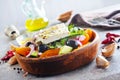 Greek salad of fresh cucumber, tomato, sweet pepper, lettuce, red onion, feta cheese and olives with olive oil. Healthy food, top Royalty Free Stock Photo