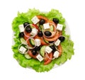 Greek salad of fresh cucumber, tomato, sweet pepper, lettuce, red onion, feta cheese and olives with olive oil Royalty Free Stock Photo