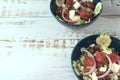 Greek salad of fresh juicy vegetables, feta cheese, herbs and olives in a blue bowl Royalty Free Stock Photo