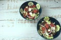 Greek salad of fresh juicy vegetables, feta cheese, herbs and olives in a blue bowl Royalty Free Stock Photo