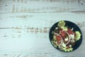 Greek salad of fresh juicy vegetables, feta cheese, herbs and olives in a blue bowl Royalty Free Stock Photo