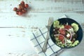 Greek salad of fresh juicy vegetables, feta cheese, herbs and olives in a blue bowl Royalty Free Stock Photo