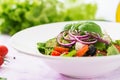 Greek salad with fresh tomato, cucumber, red onion, basil, lettuce, feta cheese, black olives Royalty Free Stock Photo