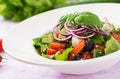 Greek salad with fresh tomato, cucumber, red onion, basil, lettuce, feta cheese, black olives Royalty Free Stock Photo
