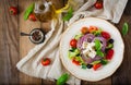 Greek salad with fresh tomato, cucumber, red onion, basil, lettuce, feta cheese, black olives and a Italian herbs Royalty Free Stock Photo