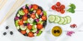 Greek salad with fresh tomatoes olives and feta cheese healthy eating food from above banner on a wooden board Royalty Free Stock Photo