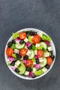 Greek salad with fresh tomatoes olives and feta cheese healthy eating food from above portrait format with copyspace copy space on Royalty Free Stock Photo