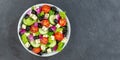 Greek salad with fresh tomatoes olives and feta cheese healthy eating food from above on a slate banner with copyspace copy space Royalty Free Stock Photo