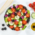 Greek salad with fresh tomatoes olives and feta cheese healthy eating food from above on a wooden board square Royalty Free Stock Photo