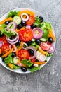 Greek salad. Fresh vegetable salad with tomato, onion, cucumbers, pepper, olives, lettuce and feta cheese. Greek salad Royalty Free Stock Photo