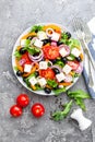 Greek salad. Fresh vegetable salad with tomato, onion, cucumbers, pepper, olives, lettuce and feta cheese. Greek salad Royalty Free Stock Photo