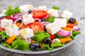 Greek salad. Fresh vegetable salad with tomato, onion, cucumbers, pepper, olives, lettuce and feta cheese. Greek salad Royalty Free Stock Photo