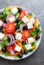 Greek salad. Fresh vegetable salad with tomato, onion, cucumbers, pepper, olives, lettuce and feta cheese. Greek salad Royalty Free Stock Photo