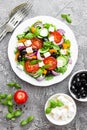 Greek salad. Fresh vegetable salad with tomato, onion, cucumbers, basil, pepper, olives, lettuce and feta cheese. Greek salad on p Royalty Free Stock Photo