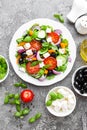 Greek salad. Fresh vegetable salad with tomato, onion, cucumbers, pepper, olives, lettuce and feta cheese. Greek salad Royalty Free Stock Photo