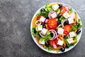 Greek salad. Fresh vegetable salad with tomato, onion, cucumbers, pepper, olives, lettuce and feta cheese. Greek salad