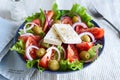 Greek salad of fresh vegetable with tomatoes, lettuce, olives, red onion and feta cheese in bowl Royalty Free Stock Photo