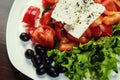 Greek salad with fresh vegetables, feta cheese and black olives,Fresh Greek salad in a bowl, top view Royalty Free Stock Photo