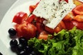 Greek salad with fresh vegetables, feta cheese and black olives,Fresh Greek salad in a bowl, top view Royalty Free Stock Photo