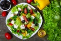 Greek salad with fresh vegetables, feta cheese and black olives on a wooden background Royalty Free Stock Photo