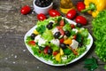 Greek salad with fresh vegetables, feta cheese and black olives on a wooden background Royalty Free Stock Photo