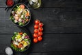 Greek salad with fresh vegetables, feta cheese and olives, on black wooden table background, top view flat lay  with copy space Royalty Free Stock Photo