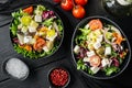 Greek salad with fresh vegetables, feta cheese and olives, on black wooden table background, top view flat lay Royalty Free Stock Photo