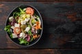 Greek salad with fresh vegetables, feta cheese and olives, on old dark  wooden table background, top view flat lay  with copy Royalty Free Stock Photo