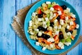 Greek salad with fresh vegetables, feta cheese, pasta and black olives