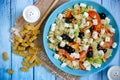 Greek salad with fresh vegetables, feta cheese, pasta and black olives Royalty Free Stock Photo