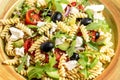 Greek salad with fresh vegetables, feta cheese, pasta and black olives. Mediterranean cuisine. Food recipe background. Close up Royalty Free Stock Photo