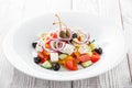 Greek salad with fresh vegetables, olives and feta cheese on wooden background close up Royalty Free Stock Photo