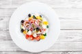 Greek salad with fresh vegetables, olives and feta cheese on wooden background close up Royalty Free Stock Photo
