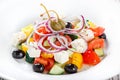 Greek salad with fresh vegetables, olives and feta cheese on wooden background close up Royalty Free Stock Photo