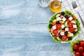 Greek salad or horiatiki salad made with pieces of tomatoes, cucumbers, onion, feta cheese, bell pepper slices, olives and dressed Royalty Free Stock Photo