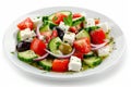 Greek salad in light plate isolated, villages salad, horiatiki salat made with tomatoes, diced feta Royalty Free Stock Photo