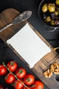 Greek salad main ingredients, fresh olives mix, feta cheese, tomatoes, on black wooden table, top view Royalty Free Stock Photo