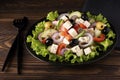 greek salad with olives and capers on a black plate Royalty Free Stock Photo