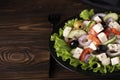 greek salad with olives and capers on a black plate Royalty Free Stock Photo