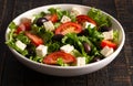 Greek Salad with Olives Tomatos and Feta Cheese on a Rustic Wood Table Royalty Free Stock Photo
