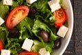 Greek Salad with Olives Tomatos and Feta Cheese on a Rustic Wood Table Royalty Free Stock Photo