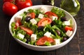 Greek Salad with Olives Tomatos and Feta Cheese on a Rustic Wood Table Royalty Free Stock Photo