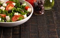 Greek Salad with Olives Tomatos and Feta Cheese on a Rustic Wood Table Royalty Free Stock Photo