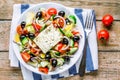 Greek salad of organic tomatoes, cucumber, red onion, olives and feta cheese Royalty Free Stock Photo