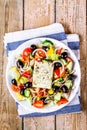 Greek salad of organic tomatoes, cucumber, red onion, olives and feta cheese Royalty Free Stock Photo