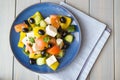 Greek salad of organic vegetables with tomatoes, cucumber, red onion, olives and feta cheese. Flat lay Royalty Free Stock Photo